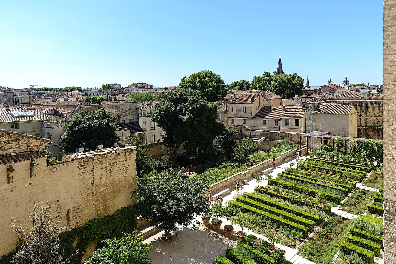 The terraced beds of the papal gardens seen from above, with the rooftops of Avignon beyond the wall
