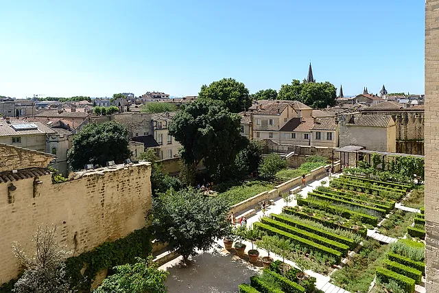 The terraced beds of the papal gardens seen from above, with the rooftops of Avignon beyond the wall