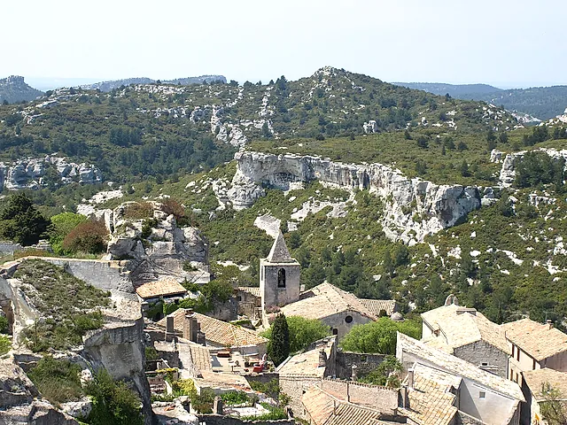 Les Baux-de-Provence: the stone roofs and bell tower of the village among the pale rocks of the Alpilles