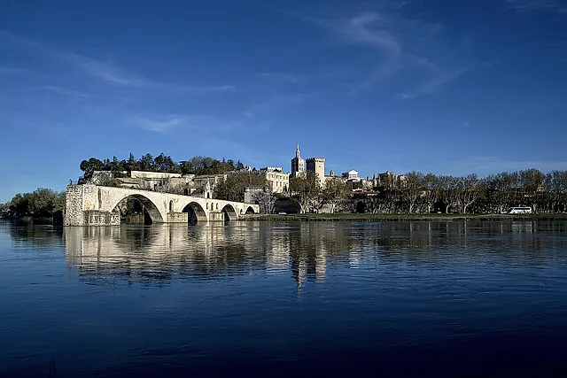 The Pont d'Avignon and, in the distance, the Palais des Papes across the Rhône under a deep blue sky